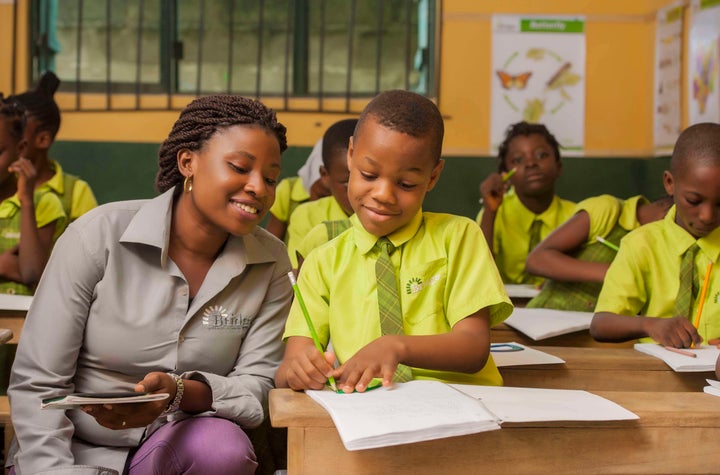 A teacher at Bridge International Academies in Nigeria guides a pupil during independent study