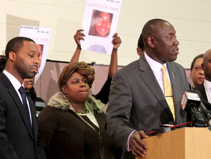 Samaria Rice, the mother of Tamir Rice, looks on as Benjamin Crump (R) speaks to the media following Rice's death. 