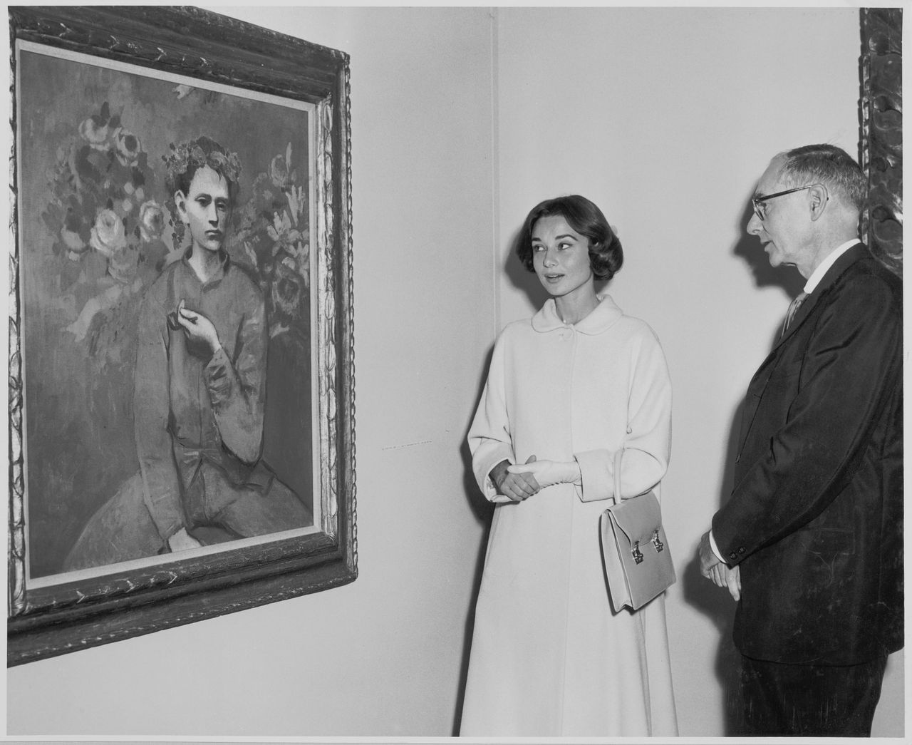 Audrey Hepburn and Alfred H. Barr, Jr. at the exhibition <em>Picasso: 75th Anniversary,</em> on view May 4, 1957 through August 25, 1957 (first floor and auditorium); May 22, 1957 through September 8, 1957 (third floor) at The Museum of Modern Art, New York.