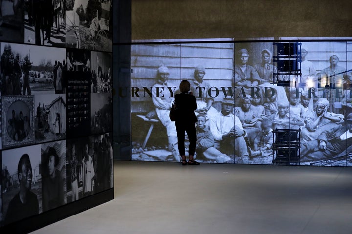 Journalists tour the David M. Rubenstein History Galleries on the lower levels of the Smithsonian's National Museum of African American History and Culture during the press preview on the National Mall, Washington, D.C., Sept. 14, 2016.