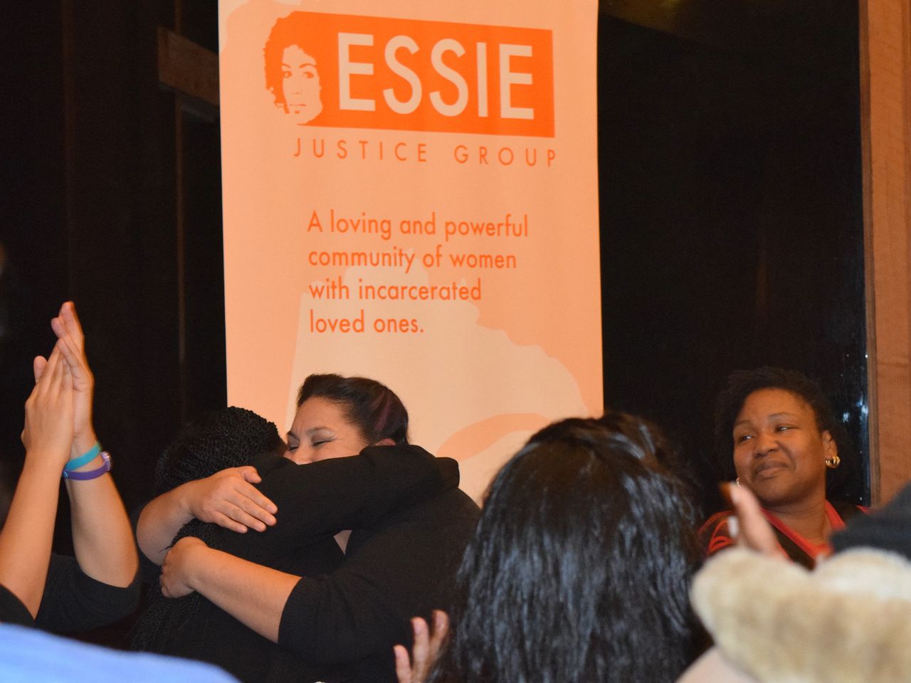 Essie members embrace at an event in January 2016.