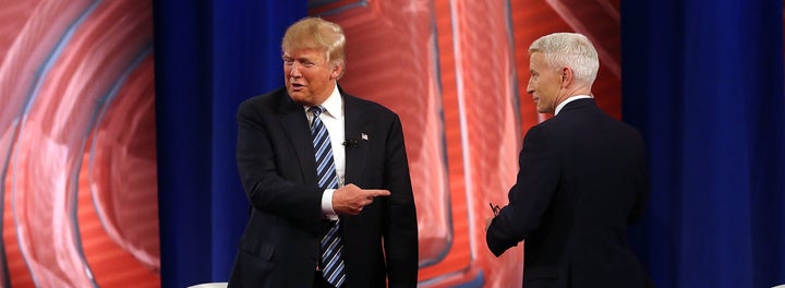 In this file photo from February, GOP presidential candidate Donald Trump speaks with CNN's Anderson Cooper. Trump has complained that Cooper shouldn't be allowed to moderate a presidential debate because of how he "behaves."