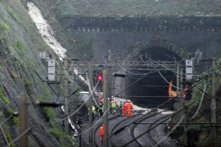 Workers at the landslip near Watford Junction station which caused a train to be derailed Friday morning.