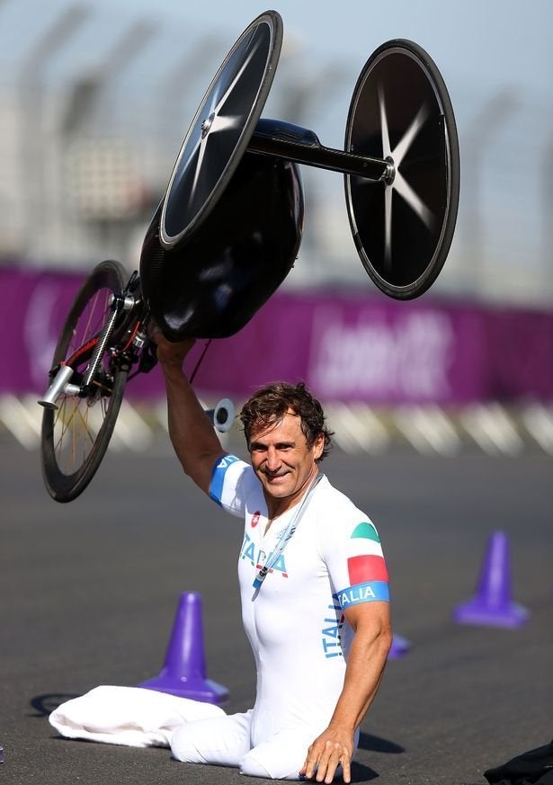 <strong>Zanardi hold his bike in the air after taking gold yesterday</strong>