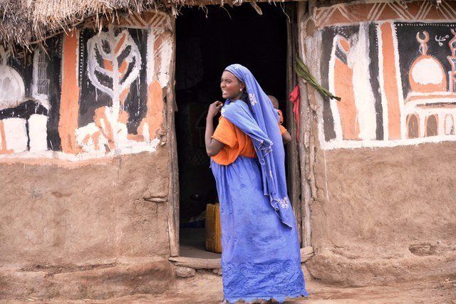 A Oromo woman, the largest ethnic group of Ethiopia, stands in front of her home.