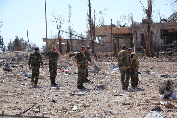 Russia has accused U.S.-led coalition jets of killing dozens of Syrian soldiers. Shown here, forces loyal to Syrian President Bashar Assad walk at a military complex in a handout photo provided by SANA on Sept. 5, 2016.