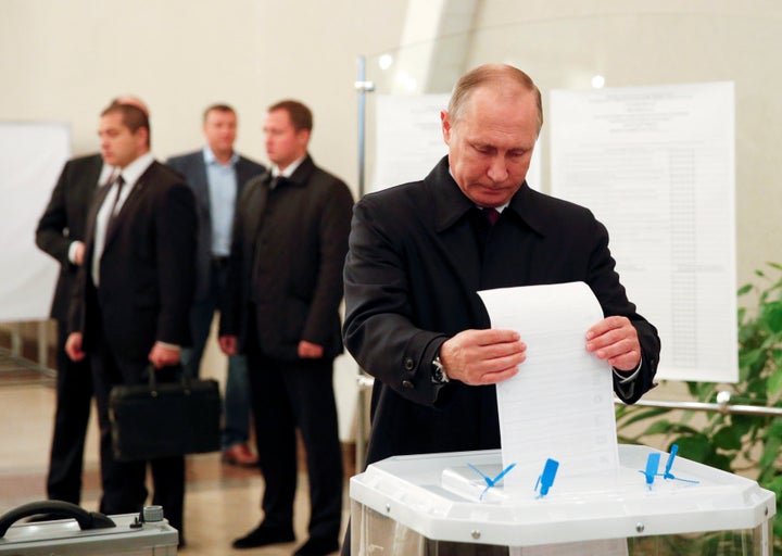 Russian President Vladimir Putin casts his ballot at a polling station during a parliamentary election in Moscow, Russia, Sep