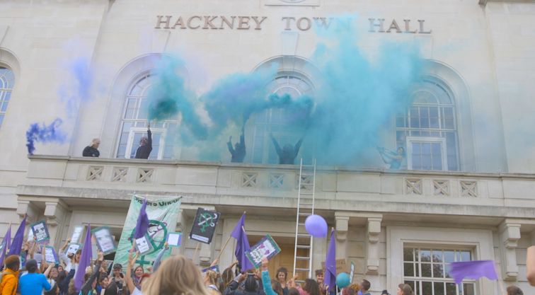 Sisters Uncut activists climb onto Hackney Town Hall balcony to demand that Mayor Glanville keeps his promises. 