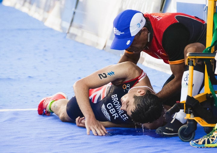 Jonny collapses after being helped to the finish.