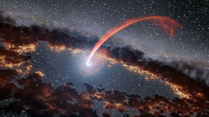 A NASA illustration showing a glowing stream of material from a star being devoured by a supermassive black hole as well as the tidal disruption flare.