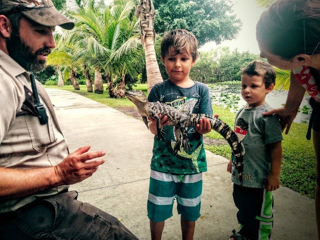 Winston and Henry King hold a baby crocodile at Everglades, Florida.