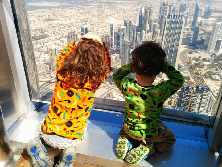 Winston and Henry King looking out of a building's windows in Dubai.