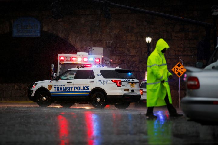 A police officer walks near an area where an explosive device left at a train station was detonated by authorities