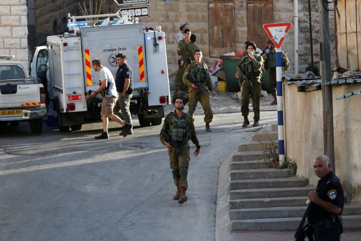 Israeli forces gather near the scene of what the Israeli military said was a stabbing attack by a Palestinian, in Tal-Rumida in the West Bank city of Hebron September 16, 2016.