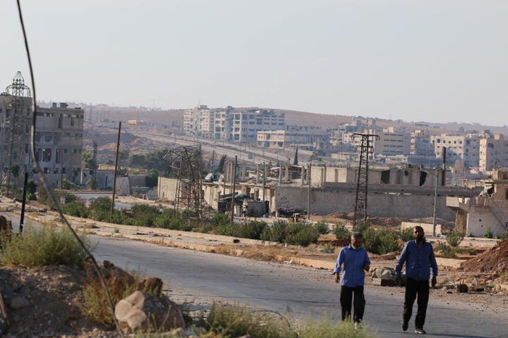 People walk near Castello road (background) in Aleppo, Syria, September 14, 2016.