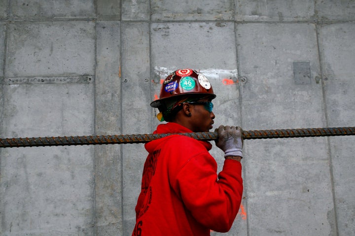 A worker carries a piece of rebar at the World Trade Center transportation hub in New York, May 6, 2013.