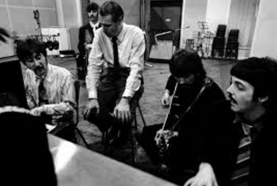 The Beatles at work in Abbey Road Studios with their musical mentor George Martin