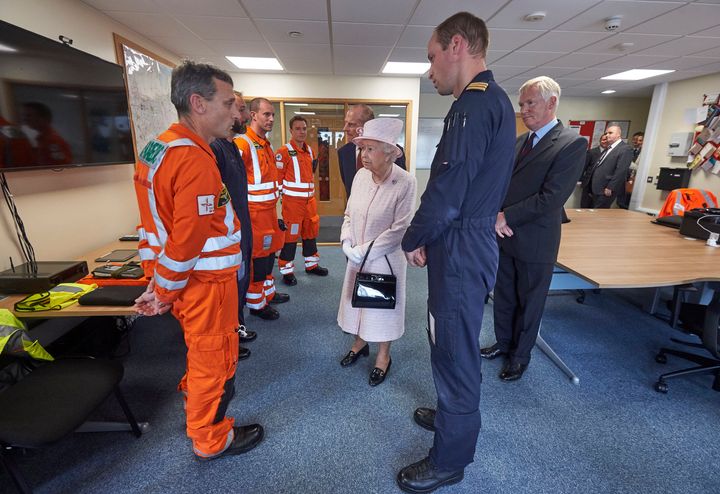 The Duke of Edinburgh shows his grandmother, the Queen, around the East Anglian Air Ambulance base