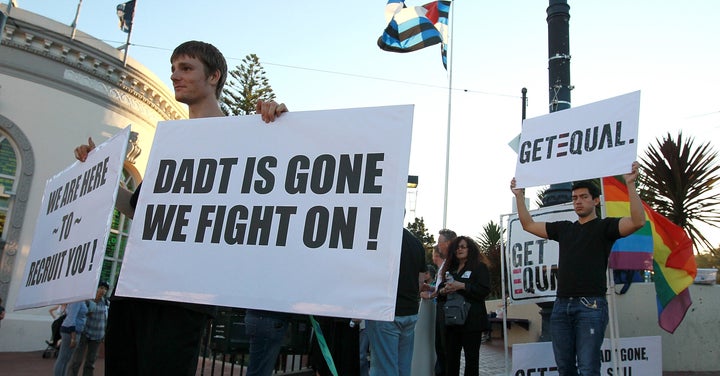 Protestors hold signs as they celebrate the end of 'Don't Ask, Don't Tell' but demand equal rights on September 20, 2011 in S