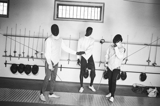 Minors incarcerated at a nearby prison participate in a fencing session at a studio in the city.