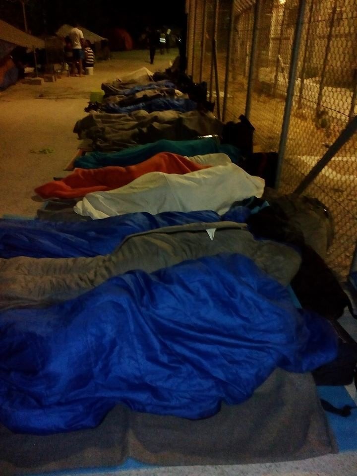 Refugees and migrants in sleeping bags outside of Moria after a blaze destroyed much of the camp.