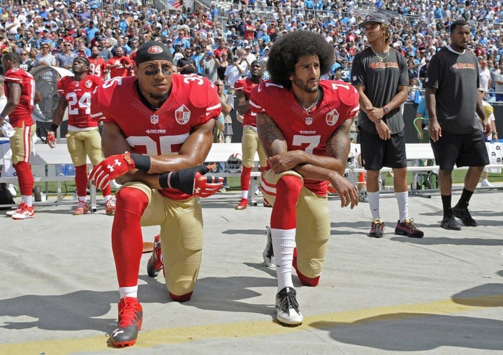 Eric Reid (left) and Colin Kaepernick (right) take a knee during The National Anthem.