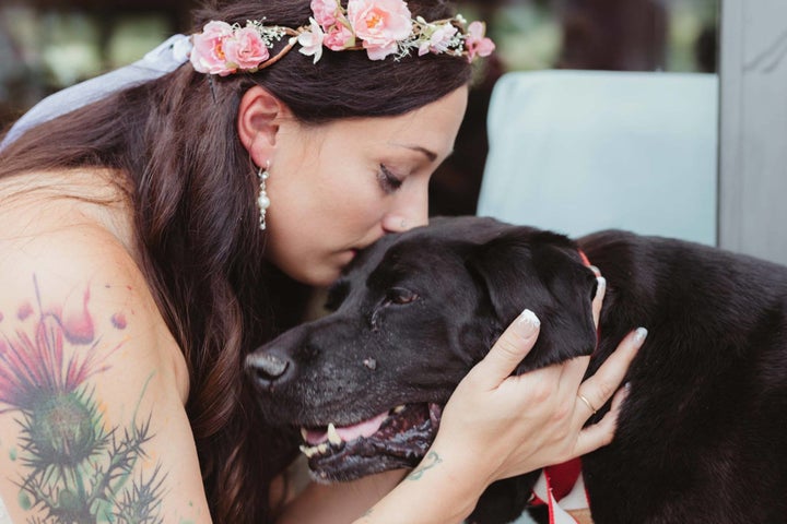 Bride Kelly O'Connell and her beloved pooch Charlie Bear share a moment on her wedding day. 