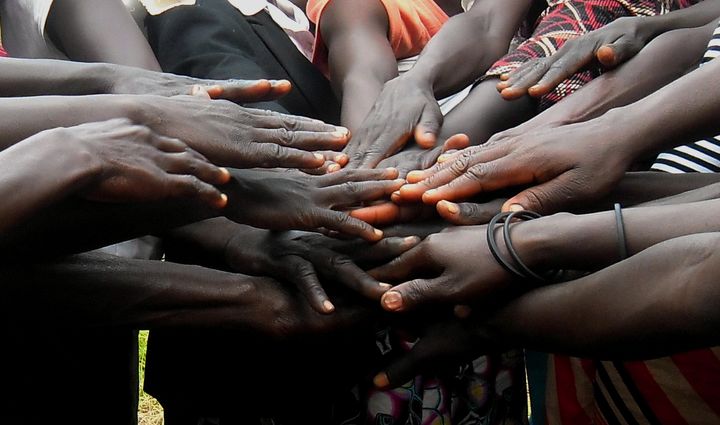 Graduates from Women for Women International's 'Hands of Peace' program in South Sudan, affirming their commitment to peacebuilding in their communities.
