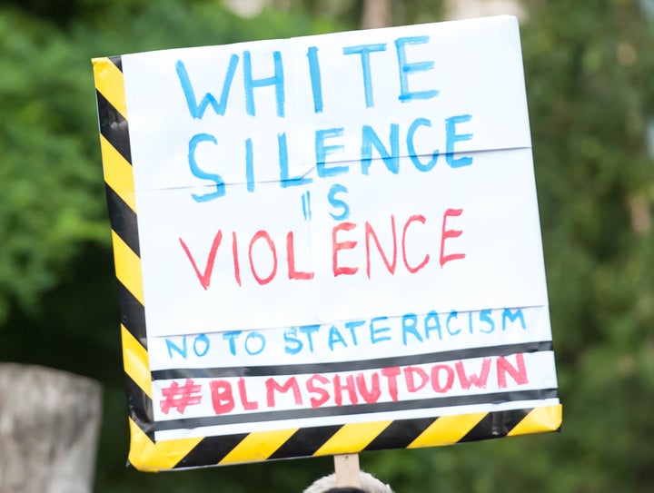 A protester at a Black Lives Matter rally holds a sign with a potent message.