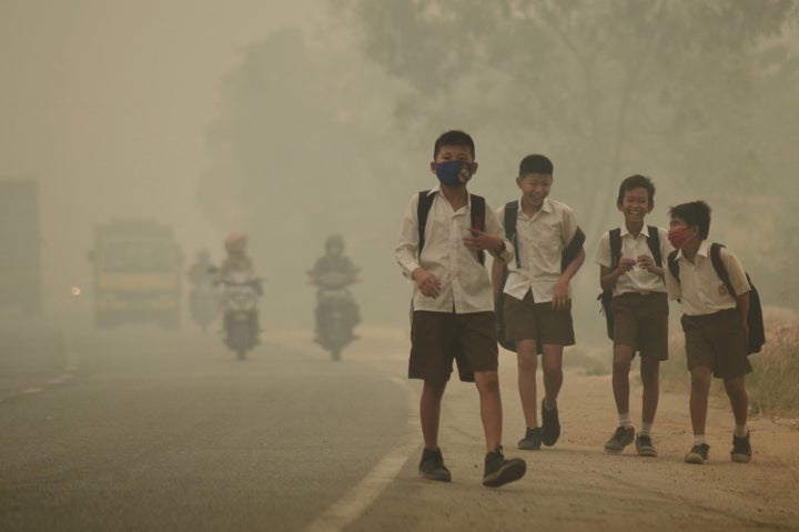 Students are released from school to return home earlier due to the haze in Jambi, Indonesia on September 2015.