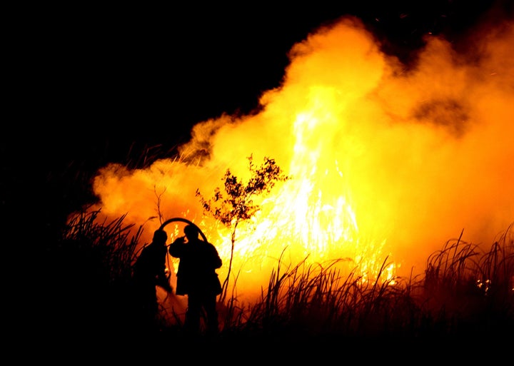 Indonesian men put out a fire in Ogan Ilir, southern Sumatra in October 2015.