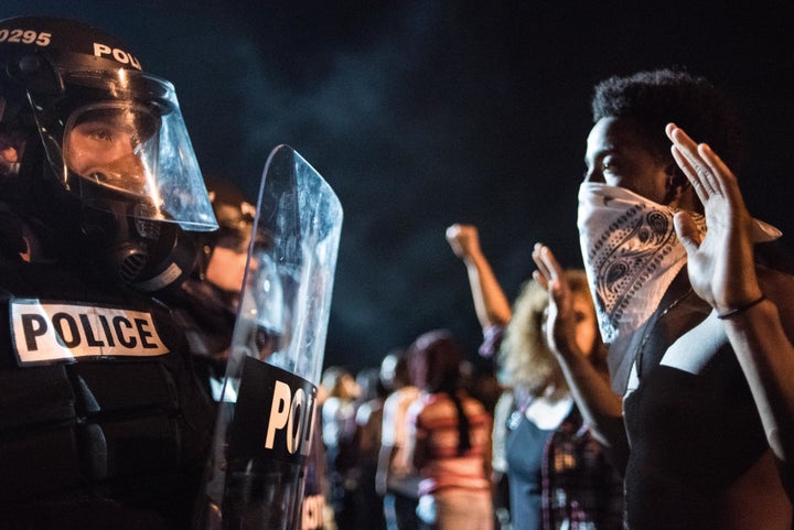 Police officers face off with protestors on the I-85 (Interstate 85) during protests following the death of a man shot by a p