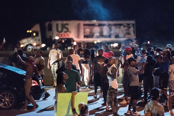 People block traffic on the I-85 (Interstate 85) during protests following the death of a man shot by a police officer.
