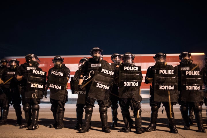 Police officers hold their line during protests on the I-85 (Interstate 85) during protests.
