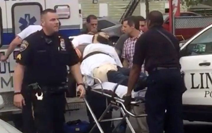 Police load Ahmad Khan Rahami, a suspect in several bomb plots, onto an ambulance after he was shot.