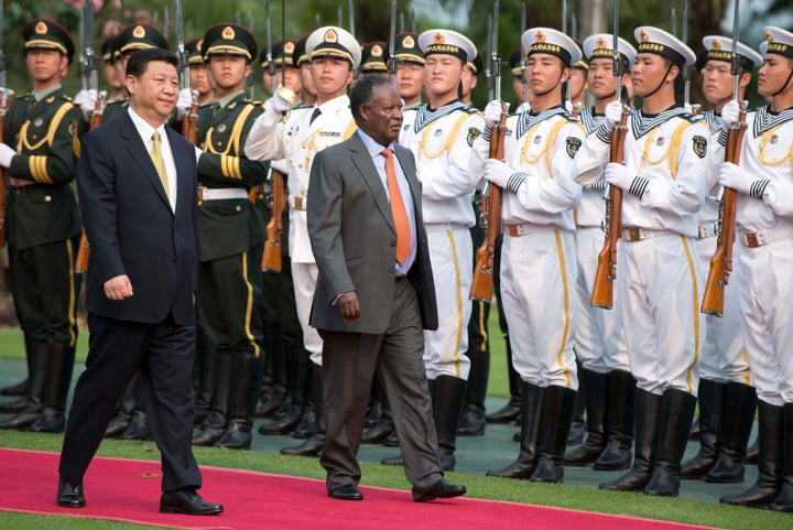 Chinese President Xi Jinping and then-Zambian President Michael Sata during a welcoming ceremony in Sanya, on the southern Chinese resort island of Hainan, on April 6, 2013.