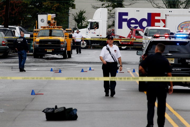 Law enforcement officers mark evidence near the site where Rahami was taken into custody in Linden, New Jersey, on Sept.