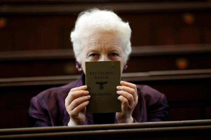 London rabbi Julia Neuberger poses for a photograph with the old German passport of her grandmother, Hermine Sara Rosenthal,