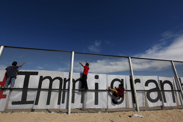 Children climb on the border fence between Ciudad Juarez, Mexico, and El Paso, Texas, during a bi-national Mass in support of migrants in February.