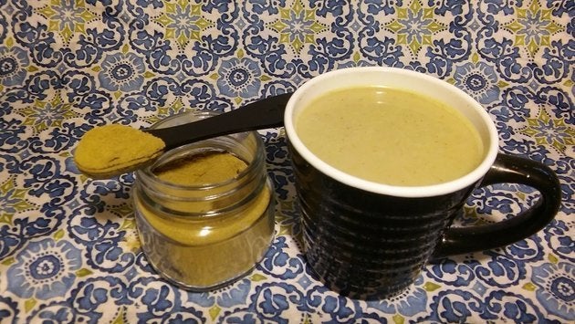 A jar of kratom powder, made from the leaves of leaves of Mitragyna speciosa, along with a mug of kratom tea.