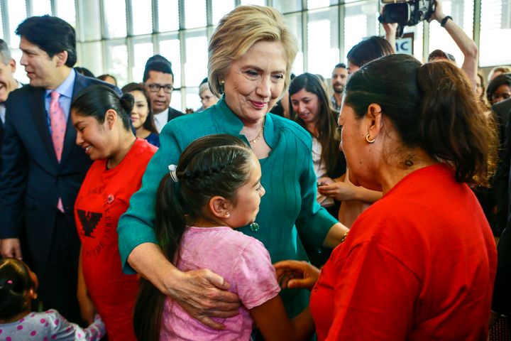 Democratic presidential candidate Hillary Clinton talks to an undocumented farm worker Maria Licea, 49, and her 9-year-old daughter Jasmin Aguilar.