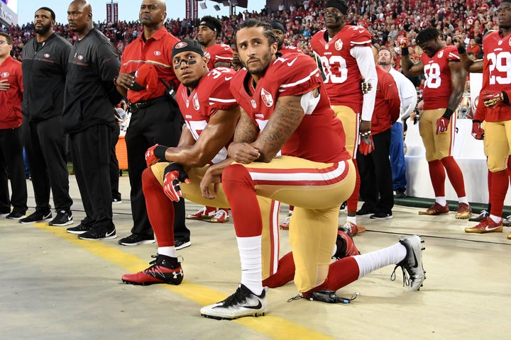 Colin Kaepernick #7 and Eric Reid #35 of the San Francisco 49ers kneel in protest during the national anthem prior to playing the Los Angeles Rams on September 12.