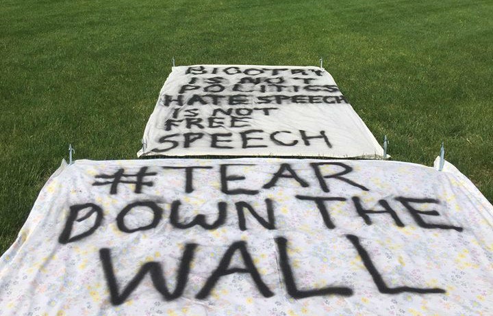 "Bigotry is not Politics | Hate Speech is not Free Speech": Anonymous students placed banners on the campus lawn in protest of #BuildAWall.