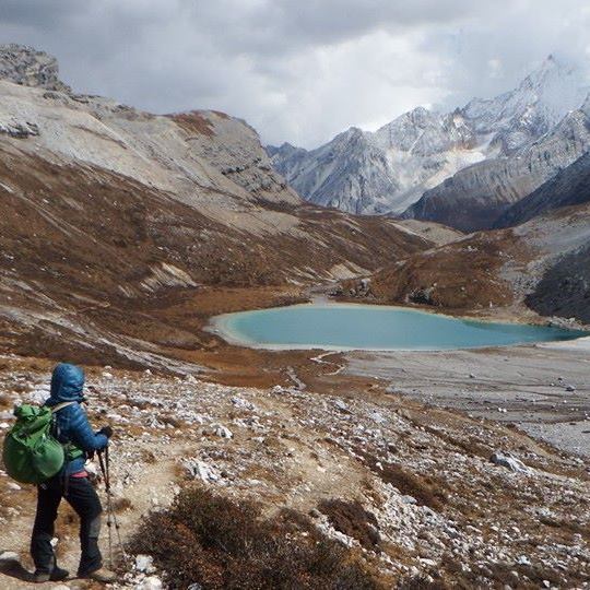 In Yading Nature Reserve of Sichuan Province of China. Trusting my intuition, I met a female traveler from Thailand and invited her to join me on a 30 kilometer hike that circumnavigates the holy peaks in the park. The 30 kilometer day hike was at high altitude and we conquered two passes at almost 5000 meters each.