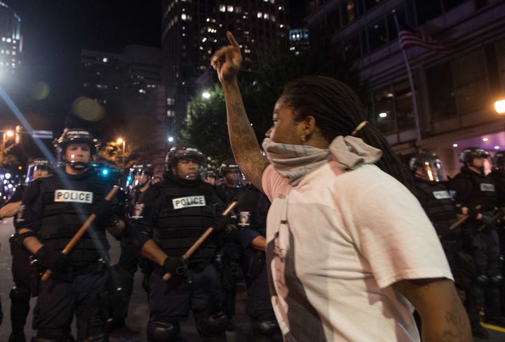 Protesters face riot police during a demonstration against police brutality in Charlotte, North Carolina, on September 21, 2016, following the shooting of Keith Lamont Scott the previous day.