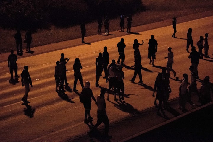 Protesters blocked traffic on a highway in Charlotte, North Carolina, on Tuesday night. In response, a conservative columnist tweeted that motorists should "run down" the demonstrators.