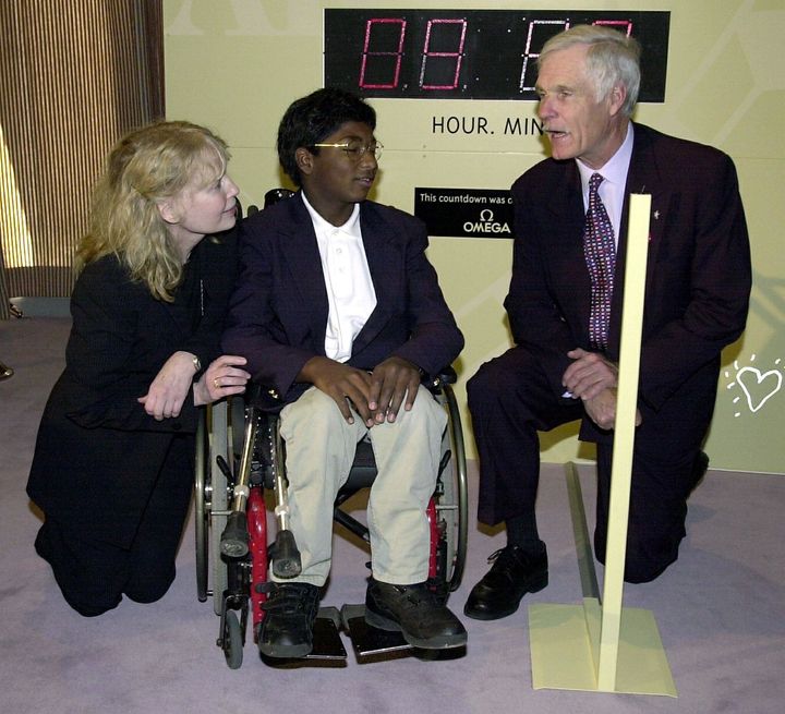 Mia Farrow and her son Thaddeus talk with media mogul Ted Turner before a United Nations conference on the eradication of polio in 2000.