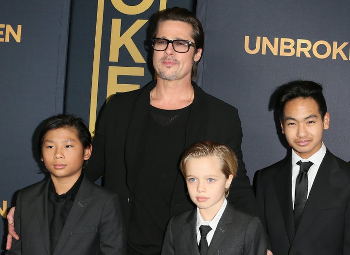 Brad Pitt and children Pax Thien Jolie-Pitt, Shiloh Nouvel Jolie-Pitt and Maddox on the red carpet in 2014. 