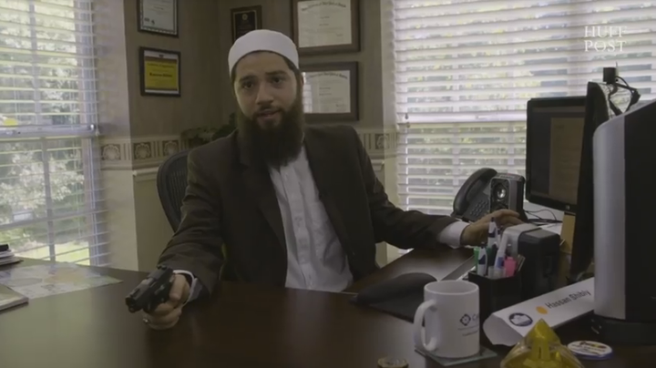 Hassan Shibly at his office, with the Sig Sauer P238 he bought in July.