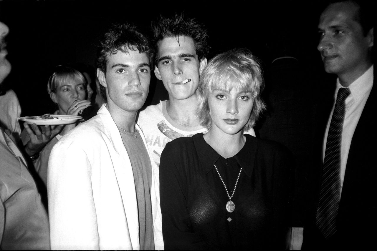 Neil Barry, Matt Dillon and Jenny Wright photographed by Patrick McMullan at the "Out of Bounds" movie premiere party in New York, 1986. 